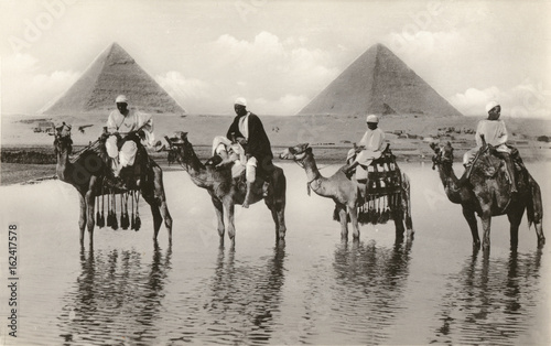 Camels and riders near the Pyramids  Egypt. Date  circa 1920s