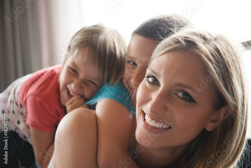 young mother spending time with kids on the floor