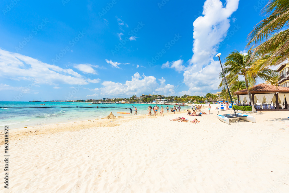 Playa del Carmen - relaxing on chair at paradise beach and city at caribbean coast of Quintana Roo, Mexico