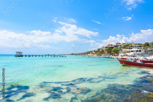 Playa del Carmen - relaxing on chair at paradise beach and city at caribbean coast of Quintana Roo, Mexico photo