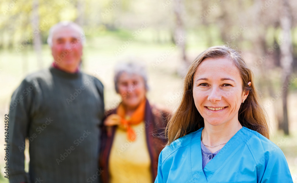 Elderly couple and young caregiver Elderly couple and young caregiver