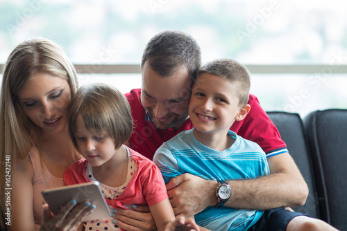 happy young couple spending time with kids