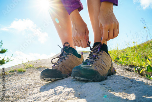 Hiking shoes - woman tying shoe laces