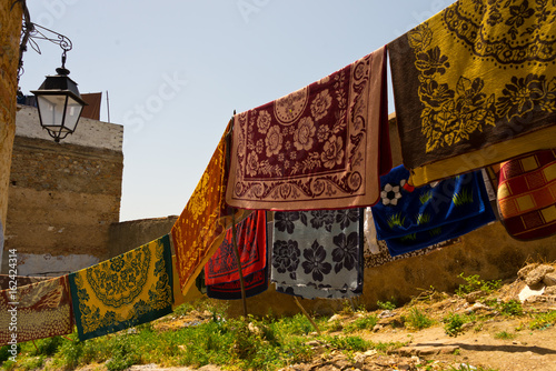 carpets drying after laundry in chefchaouen, morocco