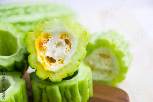 Fresh green bitter cucumber or chinese bitter melon or melon sliced in pieces photo