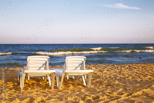 Two deckchairs on the sandy beach © pilat666