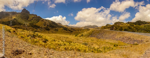 Beautiful landscape of Papallacta mountain in a sunny day with the road, with a electric cables of energy crossing the mountains in Quito Ecuador