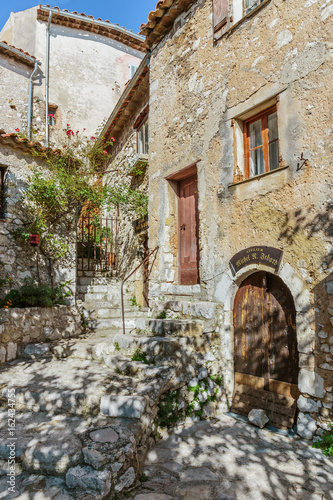 Narrow street with flowers in the old town  in France. © arbalest