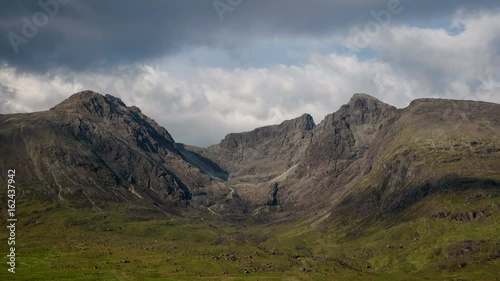 Clouds moving over Cuillin Hills in the evening. Close up on the valley between Sgurr Alasdair and Dearg. Isle of Skye, Scotland. 4k Time lapse. photo