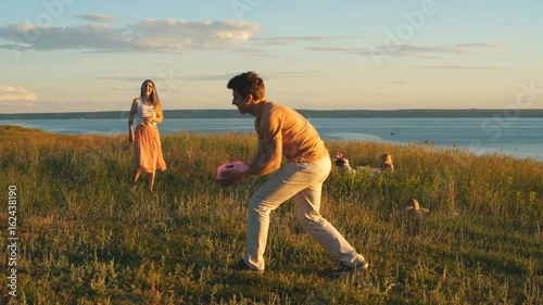 happy couple playing Frisbee
