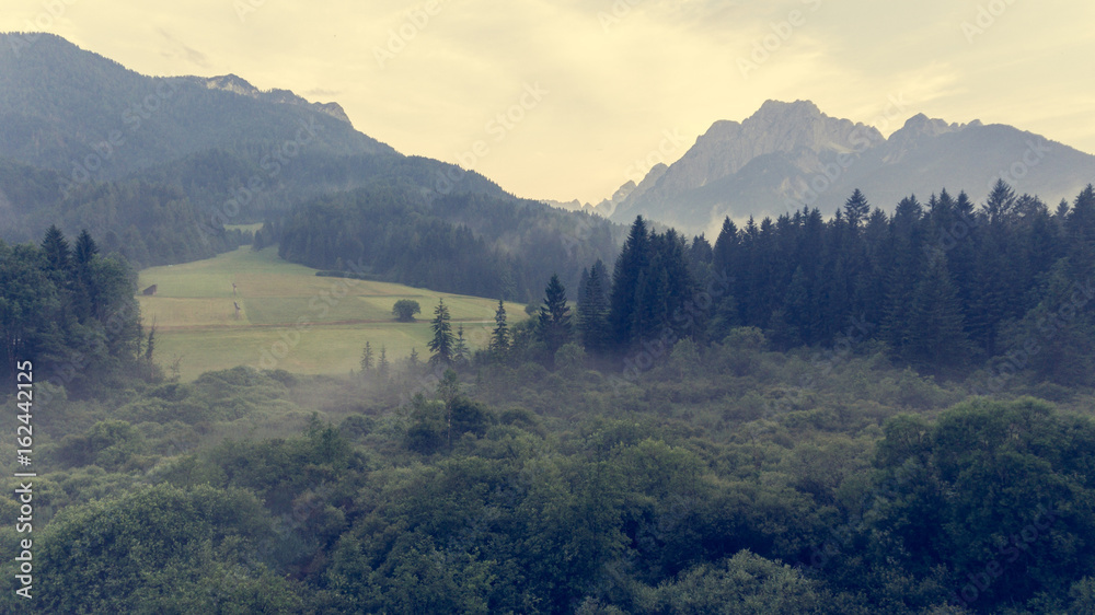 Obraz premium Aerial view of sunrise over a valley.