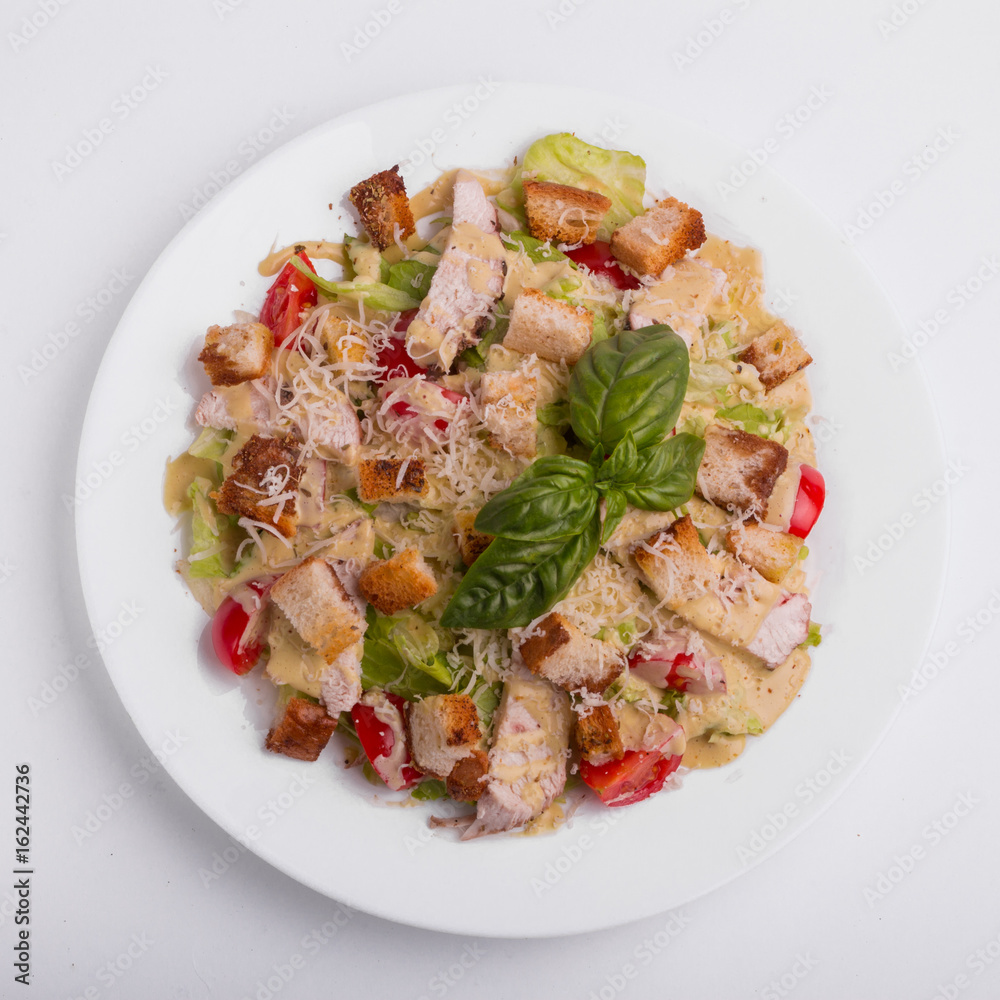 Caesar salad with chicken on a white background Caesar salad with chicken on a white background
