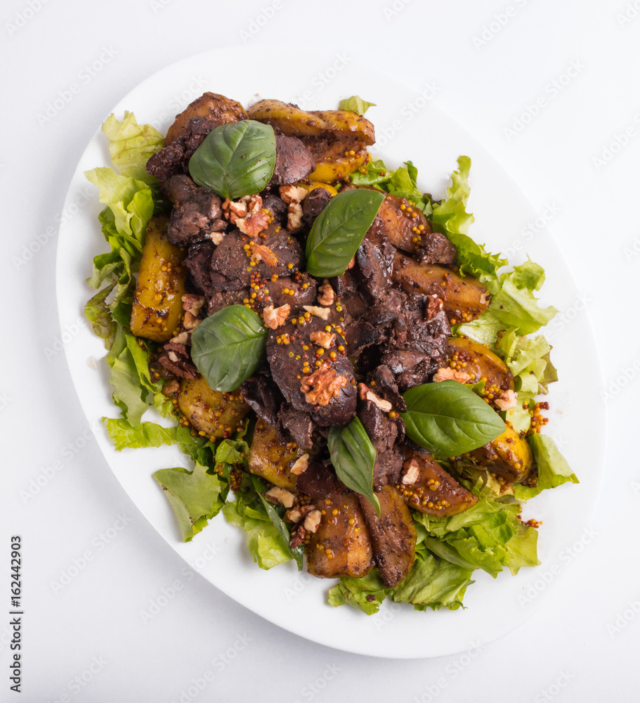 Warm salad with liver and apples on a white background Warm salad with liver and apples on a white background