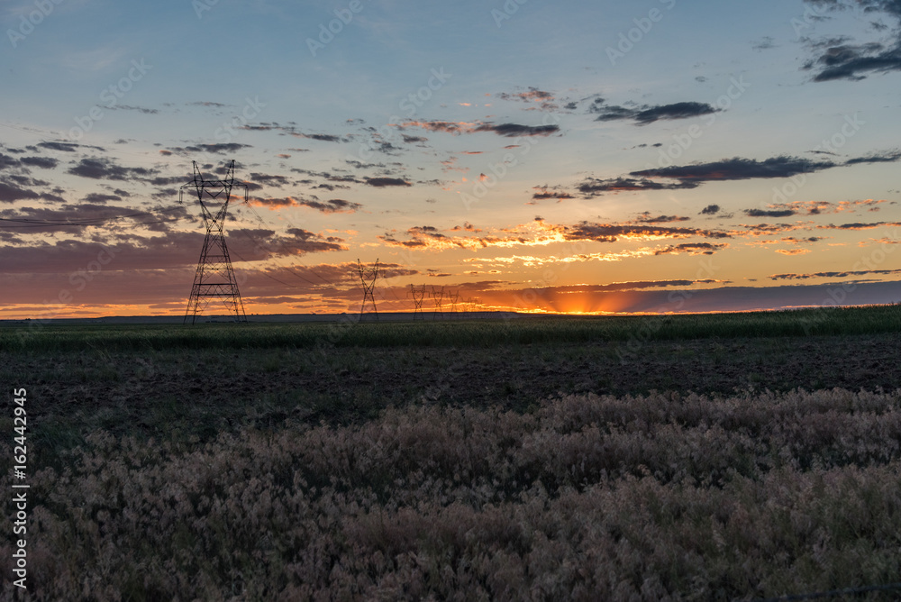 Transmission Towers During Sunset in the Eastern Plains of Colorado