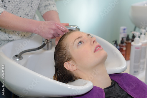 hairdresser salon woman during hair wash