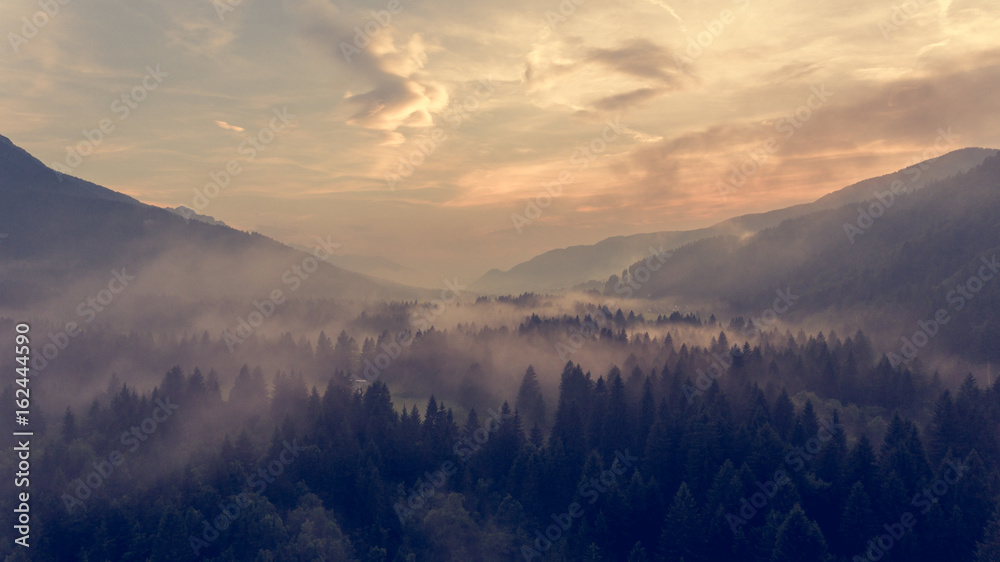 Obraz premium Aerial view of sunrise over a valley.