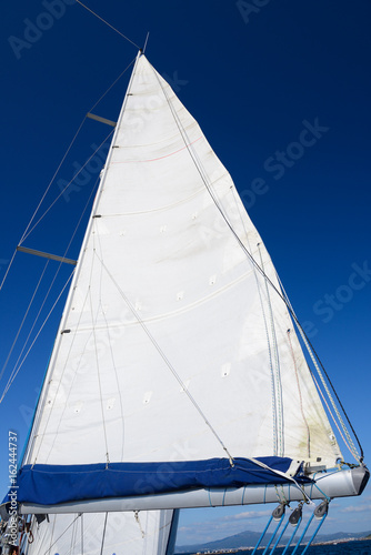white sail against the blue sky