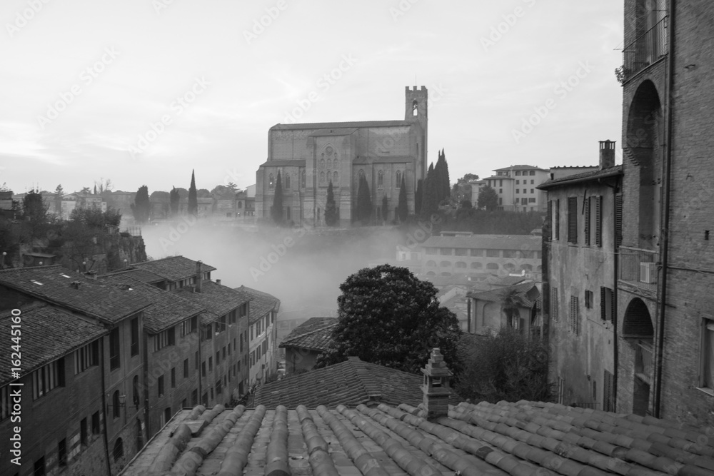 Basilica Cateriniana or Basilica of San Domenico in the mist, Siena, Tuscany, Italy. Black and white.