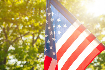 American flag with bokeh natural background and sunlight for Memorial Day or 4th of July.