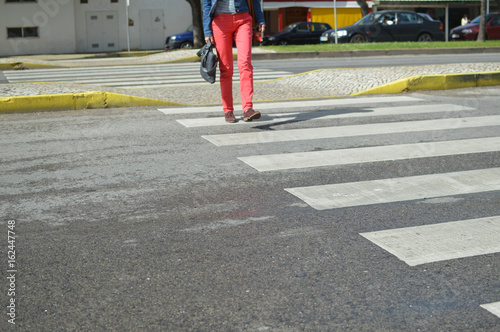 Woman walking zebra crossing outdoors background. Safe commuting sidewalk travel ransportation photo