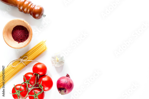 Preparing for cooking italian pasta white background top view copyspace