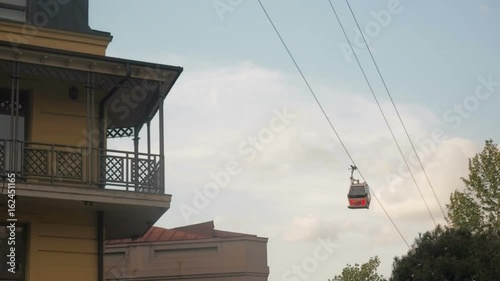 Cabs are moving along the cable car. Cableway tourist road in the city.
