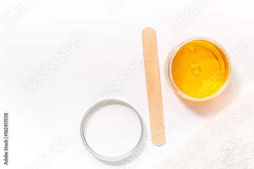 Wax and stick for depilation on white background top view copyspace