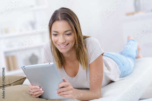 young woman using tablet browsing interne