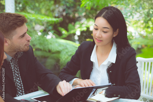 young business people making meeting and talking for analyzing marketing working at office on desk. photo