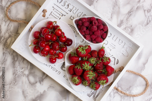 Group of fresh s fruits together cherries,raspberries and strawberries. photo