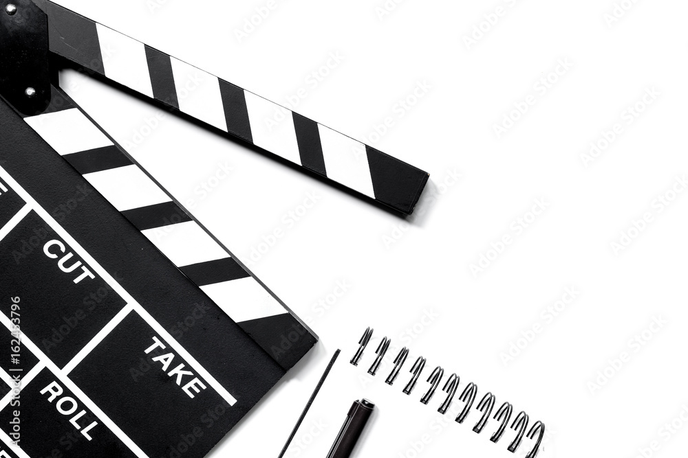 Work table of producer. Movie clapperboard and notebook on white background top view copyspace