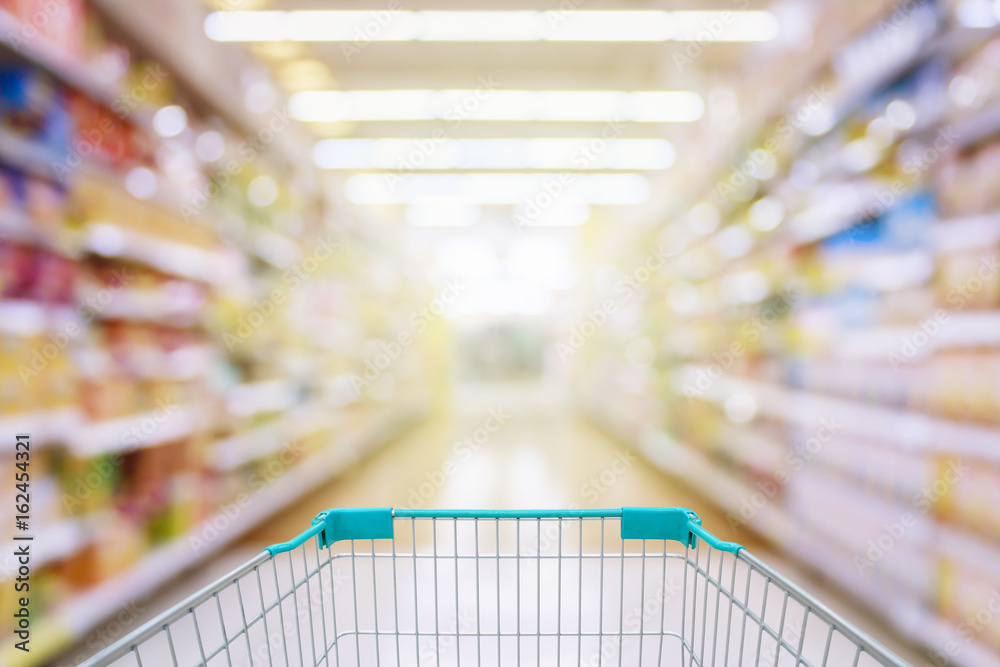 shopping cart in supermarket aisle defocused blur background
