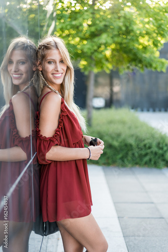 happy beautiful blonde woman smiling looking at the camera and posing