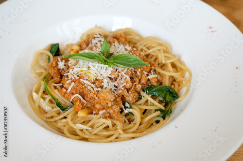 spaghetti with meat sauce and basil