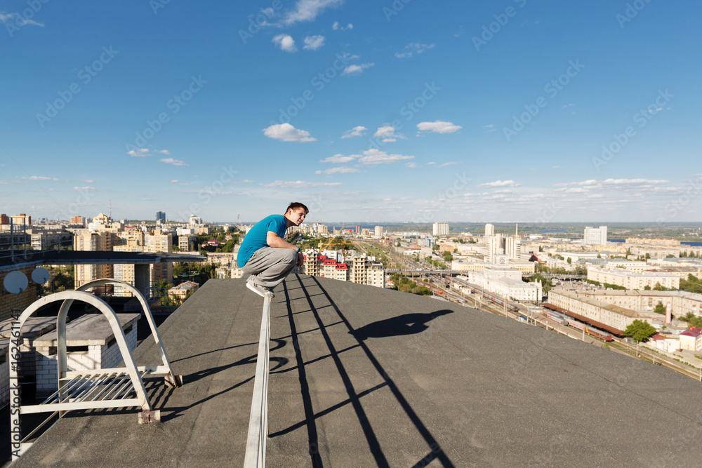 Roofer sits on the railing