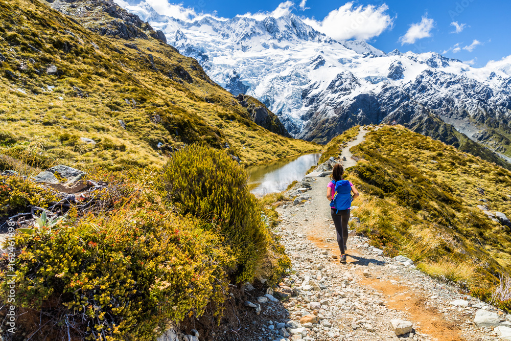 New zealand hiking girl hiker on Mount Cook Sealy Tarns trail in the southern alps, south island. Travel adventure lifestyle tourist woman walking alone on Mueller Hut route in the mountains.