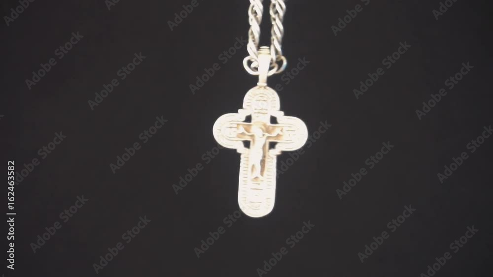 Christian cross on black background,slow motion. Christian cross on black background,slow motion.