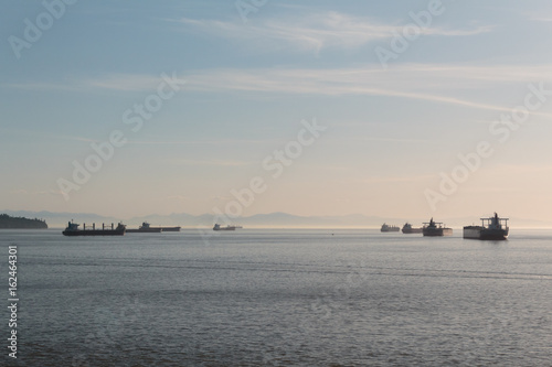 Photo of distant ships and mountain on the horizon