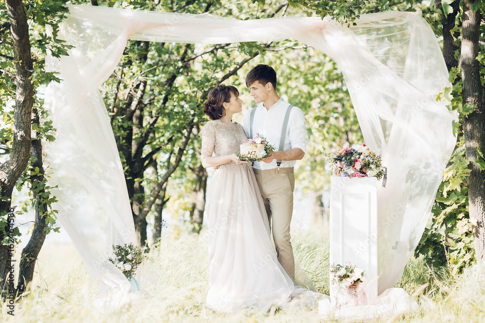 wedding couple on  nature.  bride and groom with cake  at  wedding. 
