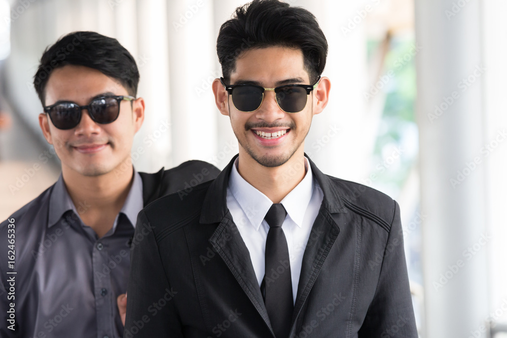 Two young smart asian businessmen are smiling and happy Two young smart asian businessmen are smiling and happy