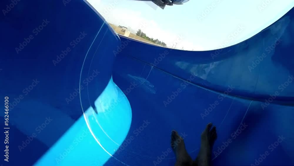 A man slides on a water slide. Active rest, water park, water slides, action camera.