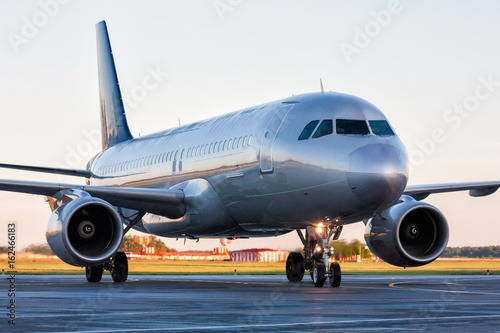 Close-up taxiing passenger airplane at the airport apron