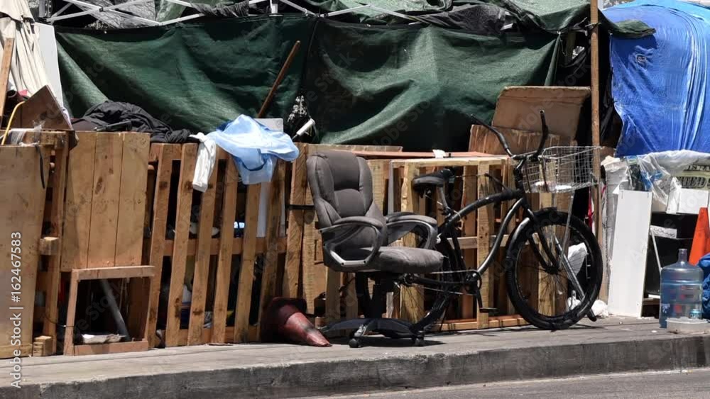 Pan shot down a street on skid row in Los Angeles
