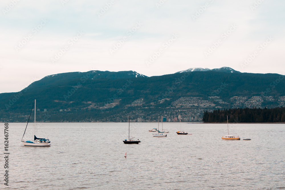 Photo of boats and mountains at English Bay, Vancouver, BC Photo of boats and mountains at English Bay, Vancouver, BC