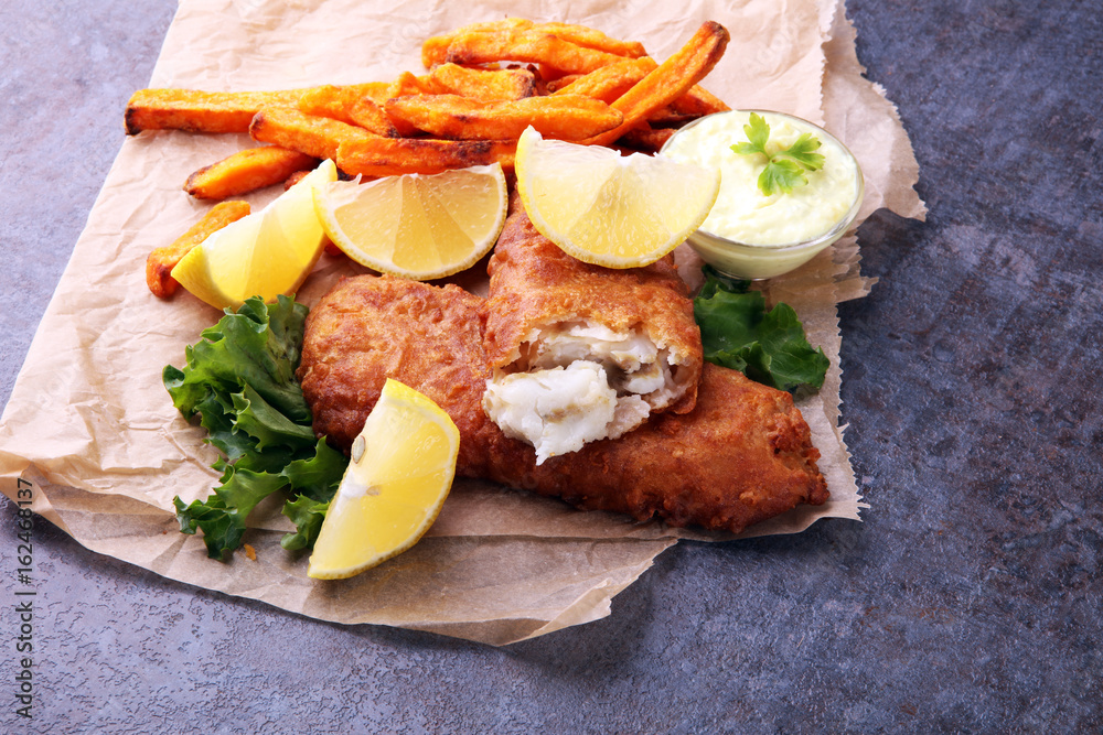 traditional British fish and chips on brown paper traditional British fish and chips on brown paper