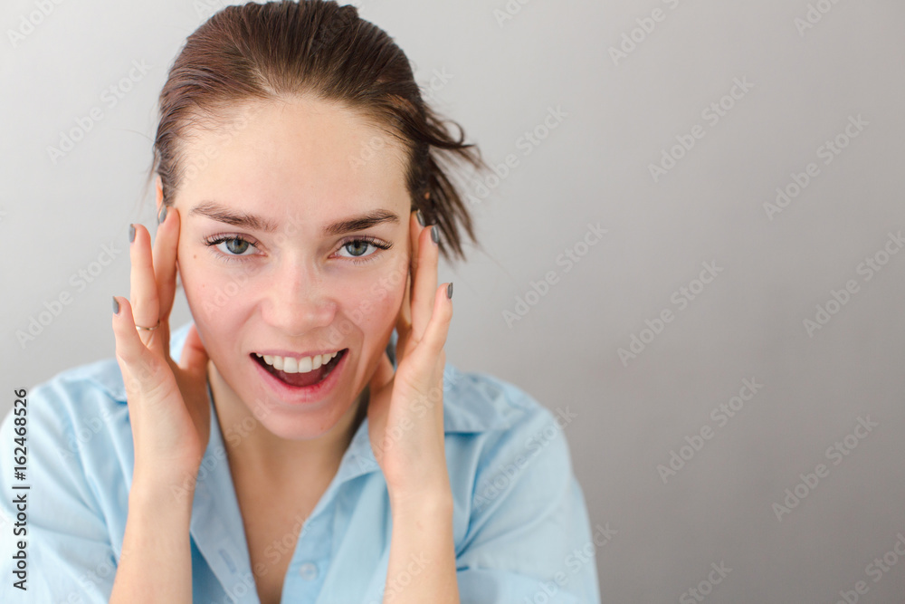 Young woman touching cheeks self-massage Young woman touching cheeks self-massage