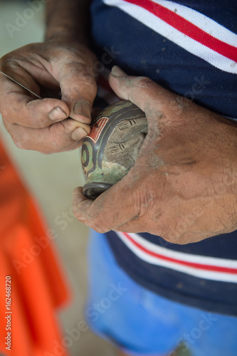 Obraz na płótnie Guaitil Artisnal Village, Costa Rica - April 18, 2016: A potter shows how he makes ceramics in Guaitil Artisanal Village, Costa Rica w salonie
