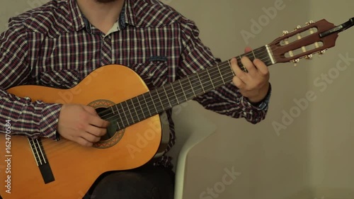 Man playing classic guitar, neylon strings. photo