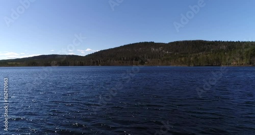 Glittering pond, Cinema 4k aerial flying above pond karankalampi, near pielinen lake and btween mountains, in koli national park, Lieksa, Karjala, Finland photo