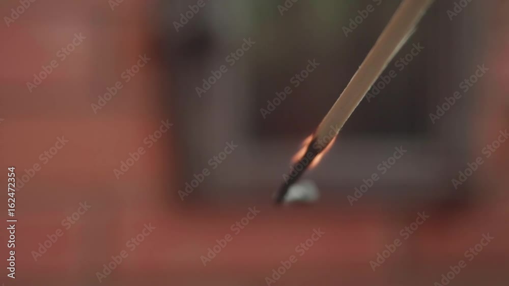 Big match burns against the backdrop of a brick fireplace Big match burns against the backdrop of a brick fireplace